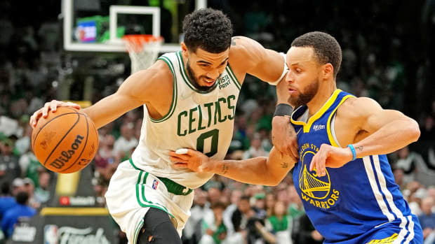 Jun 16, 2022; Boston, Massachusetts, USA; Boston Celtics forward Jayson Tatum (0) handles the ball against Golden State Warriors guard Stephen Curry (30) during the fourth quarter in game six of the 2022 NBA Finals at TD Garden.